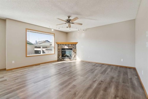 111 Luxstone Crescent Sw, Airdrie, AB - Indoor Photo Showing Living Room With Fireplace