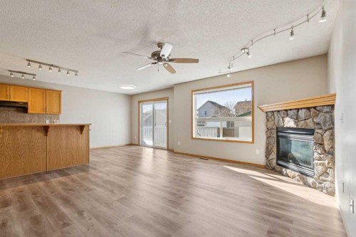 111 Luxstone Crescent Sw, Airdrie, AB - Indoor With Fireplace