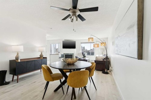 102-6102 Valleyview Park Se, Calgary, AB - Indoor Photo Showing Dining Room With Fireplace