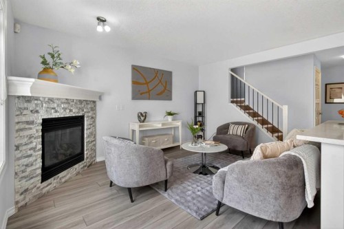 216 Royal Crest View Nw, Calgary, AB - Indoor Photo Showing Living Room With Fireplace
