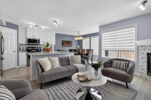 216 Royal Crest View Nw, Calgary, AB - Indoor Photo Showing Living Room With Fireplace