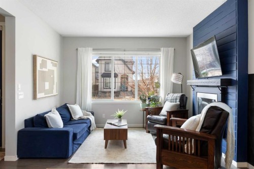 44 Marquis Link Se, Calgary, AB - Indoor Photo Showing Living Room With Fireplace
