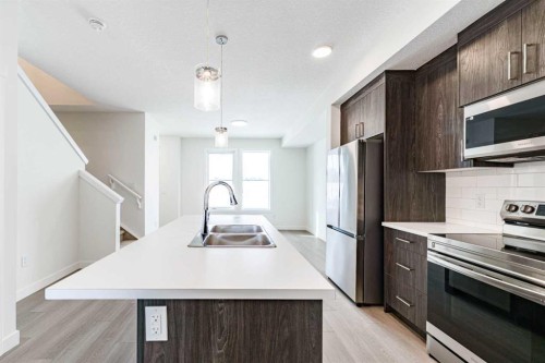 1921 Mccaskill Drive, Crossfield, AB - Indoor Photo Showing Kitchen With Double Sink With Upgraded Kitchen