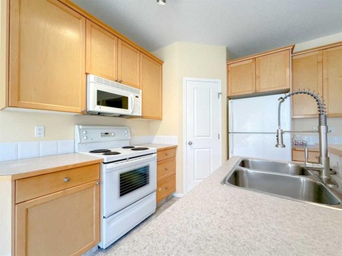 21 Panamount Hill Nw, Calgary, AB - Indoor Photo Showing Kitchen With Double Sink