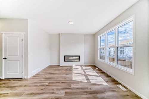 1069 Sawgrass Link Nw, Airdrie, AB - Indoor Photo Showing Other Room With Fireplace