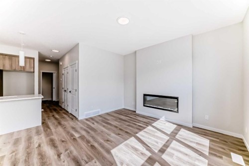 1069 Sawgrass Link Nw, Airdrie, AB - Indoor Photo Showing Living Room With Fireplace