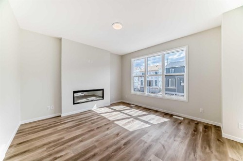 1069 Sawgrass Link Nw, Airdrie, AB - Indoor Photo Showing Living Room With Fireplace