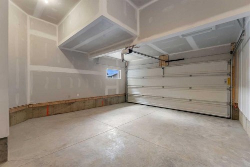 15 Heritage Heath, Cochrane, AB - Indoor Photo Showing Garage