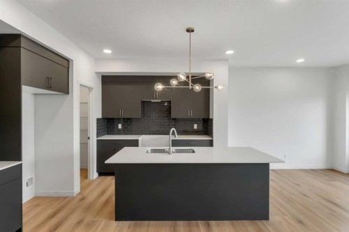 15 Heritage Heath, Cochrane, AB - Indoor Photo Showing Kitchen With Double Sink With Upgraded Kitchen