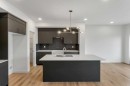 15 Heritage Heath, Cochrane, AB  - Indoor Photo Showing Kitchen With Double Sink With Upgraded Kitchen 
