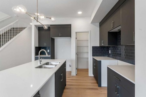 15 Heritage Heath, Cochrane, AB - Indoor Photo Showing Kitchen With Double Sink With Upgraded Kitchen