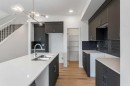 15 Heritage Heath, Cochrane, AB  - Indoor Photo Showing Kitchen With Double Sink With Upgraded Kitchen 