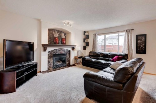 41 Chapman Close Se, Calgary, AB - Indoor Photo Showing Living Room With Fireplace
