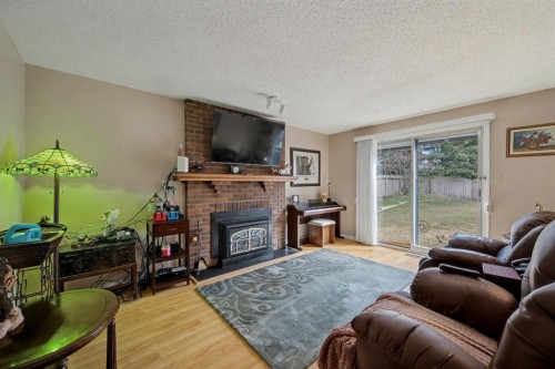983 Woodbine Boulevard Sw, Calgary, AB - Indoor Photo Showing Living Room With Fireplace