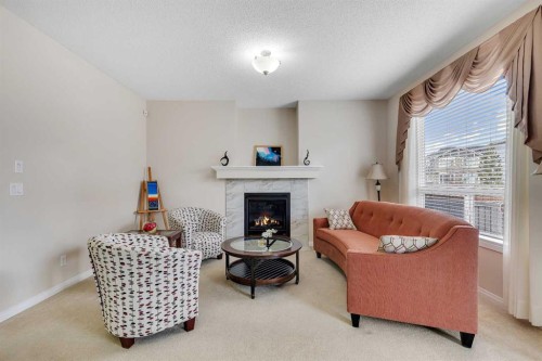 32 Panatella Row Nw, Calgary, AB - Indoor Photo Showing Living Room With Fireplace