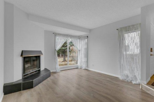 220 Cedarbrook Bay Sw, Calgary, AB - Indoor Photo Showing Living Room With Fireplace