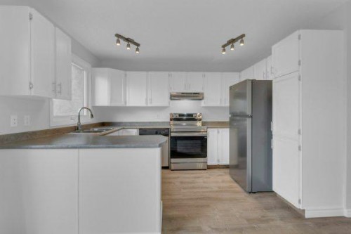 220 Cedarbrook Bay Sw, Calgary, AB - Indoor Photo Showing Kitchen With Stainless Steel Kitchen