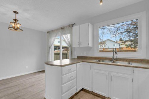 220 Cedarbrook Bay Sw, Calgary, AB - Indoor Photo Showing Kitchen With Double Sink