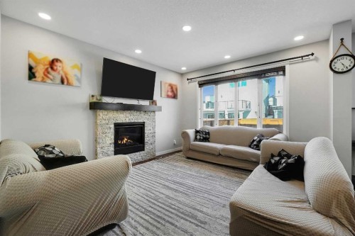 216 Carringvue Manor Nw, Calgary, AB - Indoor Photo Showing Living Room With Fireplace