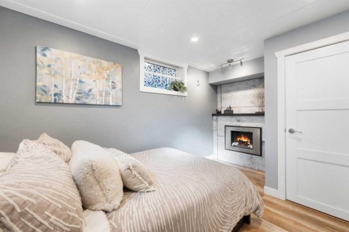 6 Grove Hill Place Sw, Calgary, AB - Indoor Photo Showing Bedroom With Fireplace
