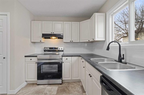 32 Deerpoint Road Se, Calgary, AB - Indoor Photo Showing Kitchen With Stainless Steel Kitchen With Double Sink