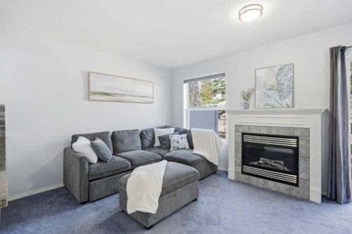 43 Everstone Place Sw, Calgary, AB - Indoor Photo Showing Living Room With Fireplace