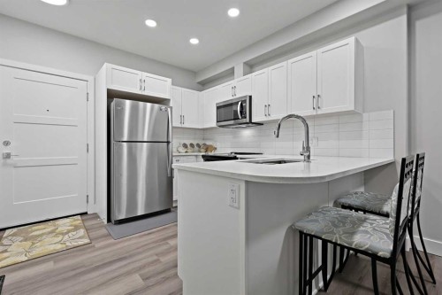 105-8355 19 Avenue Sw, Calgary, AB - Indoor Photo Showing Kitchen With Stainless Steel Kitchen