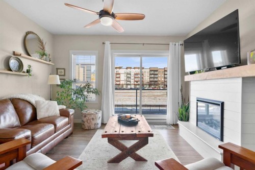 211-20 Seton Park Se, Calgary, AB - Indoor Photo Showing Living Room With Fireplace