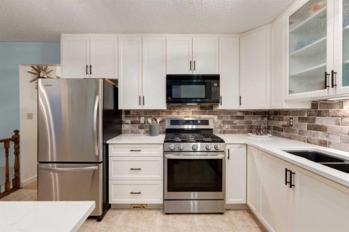 8 Deerwood Road Se, Calgary, AB - Indoor Photo Showing Kitchen With Double Sink