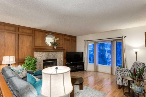 8 Deerwood Road Se, Calgary, AB - Indoor Photo Showing Living Room With Fireplace