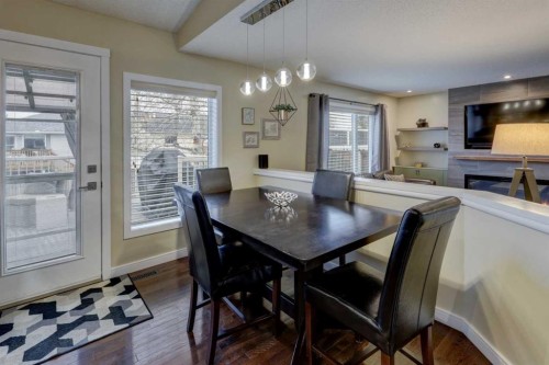 19 Riverstone Crescent Se, Calgary, AB - Indoor Photo Showing Dining Room With Fireplace