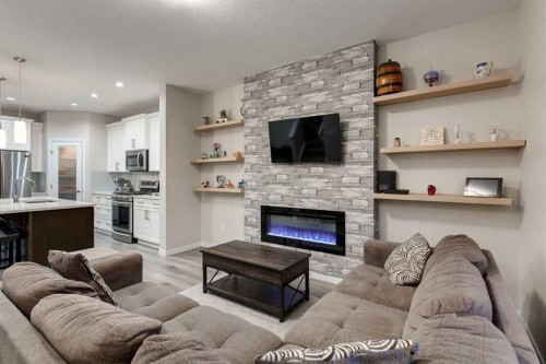 123 Drake Landing Loop, Okotoks, AB - Indoor Photo Showing Living Room With Fireplace