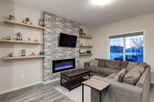 123 Drake Landing Loop, Okotoks, AB - Indoor Photo Showing Living Room With Fireplace