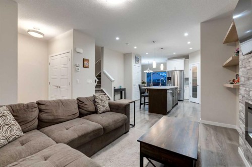 123 Drake Landing Loop, Okotoks, AB - Indoor Photo Showing Living Room With Fireplace