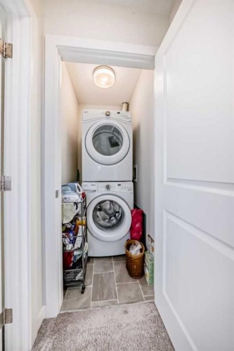 1302 Jumping Pound Common, Cochrane, AB - Indoor Photo Showing Laundry Room