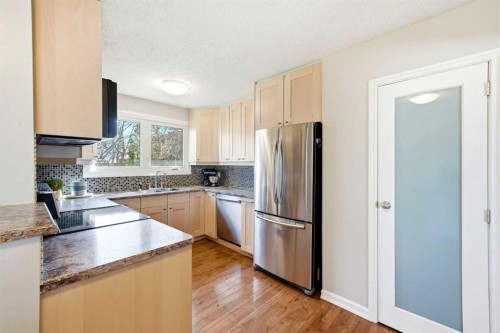 14775 Deer Ridge Drive Se, Calgary, AB - Indoor Photo Showing Kitchen With Double Sink