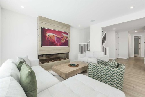 181 Amblehurst Rise Nw, Calgary, AB - Indoor Photo Showing Living Room With Fireplace