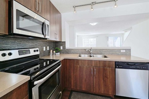 38 Cranford Drive Se, Calgary, AB - Indoor Photo Showing Kitchen With Stainless Steel Kitchen With Double Sink