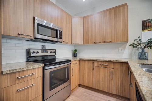 124-300 Marina Drive, Chestermere, AB - Indoor Photo Showing Kitchen With Stainless Steel Kitchen With Double Sink