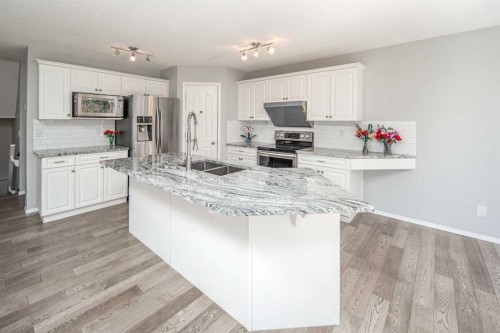 32 Cougarstone Square Sw, Calgary, AB - Indoor Photo Showing Kitchen With Stainless Steel Kitchen With Double Sink With Upgraded Kitchen