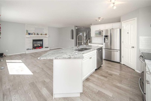 32 Cougarstone Square Sw, Calgary, AB - Indoor Photo Showing Kitchen With Stainless Steel Kitchen With Double Sink With Upgraded Kitchen