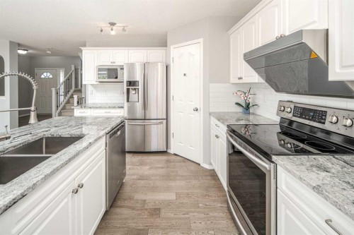 32 Cougarstone Square Sw, Calgary, AB - Indoor Photo Showing Kitchen With Stainless Steel Kitchen With Double Sink With Upgraded Kitchen