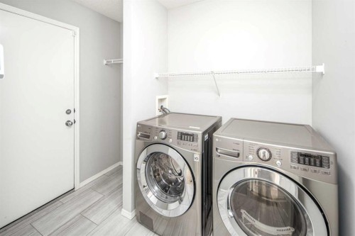 32 Cougarstone Square Sw, Calgary, AB - Indoor Photo Showing Laundry Room