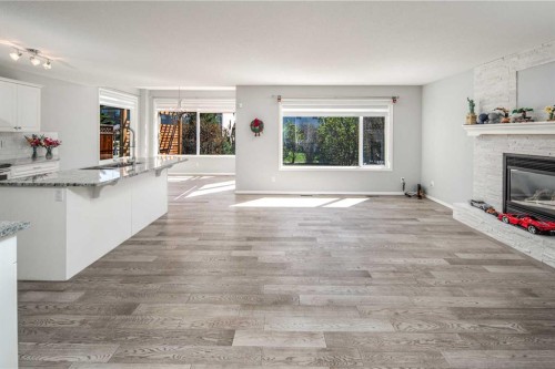 32 Cougarstone Square Sw, Calgary, AB - Indoor Photo Showing Other Room With Fireplace