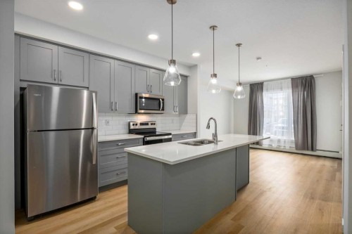 101-200 Shawnee Square Sw, Calgary, AB - Indoor Photo Showing Kitchen With Stainless Steel Kitchen With Double Sink With Upgraded Kitchen