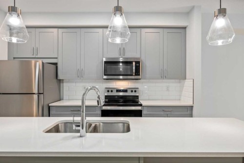 101-200 Shawnee Square Sw, Calgary, AB - Indoor Photo Showing Kitchen With Stainless Steel Kitchen With Double Sink With Upgraded Kitchen