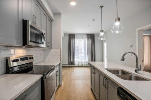 101-200 Shawnee Square Sw, Calgary, AB - Indoor Photo Showing Kitchen With Stainless Steel Kitchen With Double Sink With Upgraded Kitchen