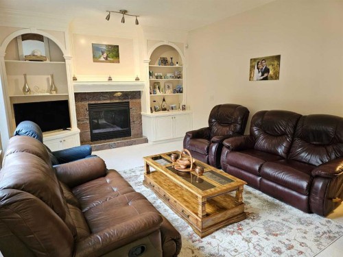 253 Patterson Boulevard Sw, Calgary, AB - Indoor Photo Showing Living Room With Fireplace