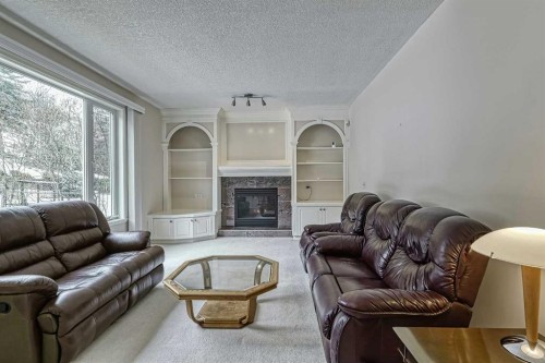 253 Patterson Boulevard Sw, Calgary, AB - Indoor Photo Showing Living Room With Fireplace