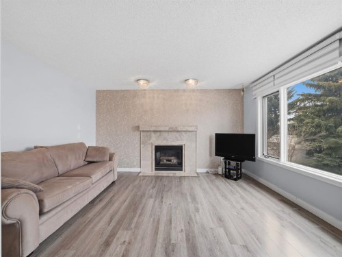 247 Hidden Valley Place Nw, Calgary, AB - Indoor Photo Showing Living Room With Fireplace